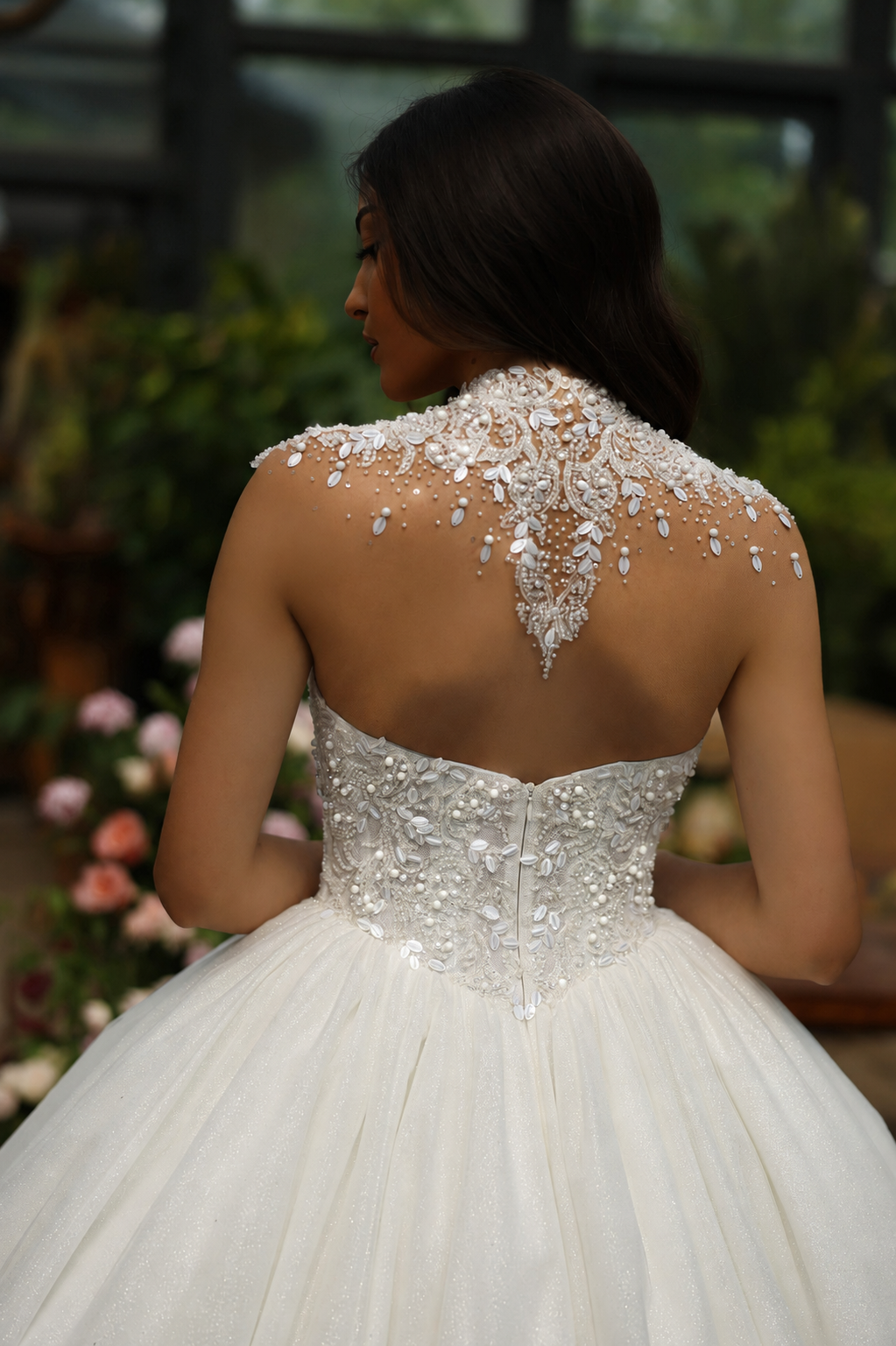 Bride wearing an intricately beaded gown with a high lace back